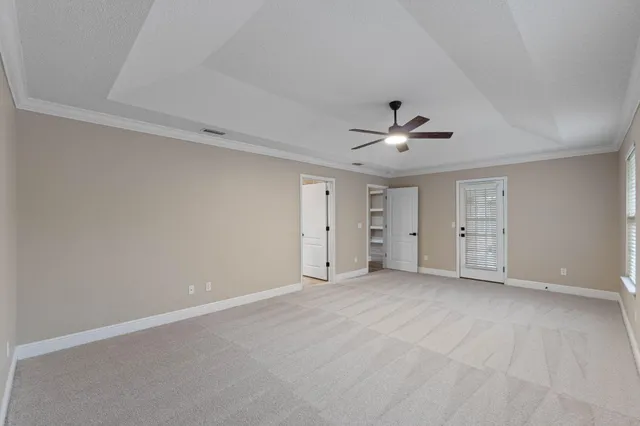 a view of an empty room with a ceiling fan