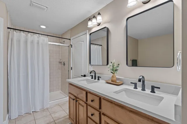 a bathroom with double vanity sinks and a mirror