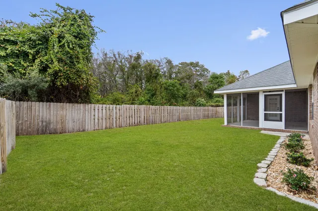 a view of a house with a yard and sitting area