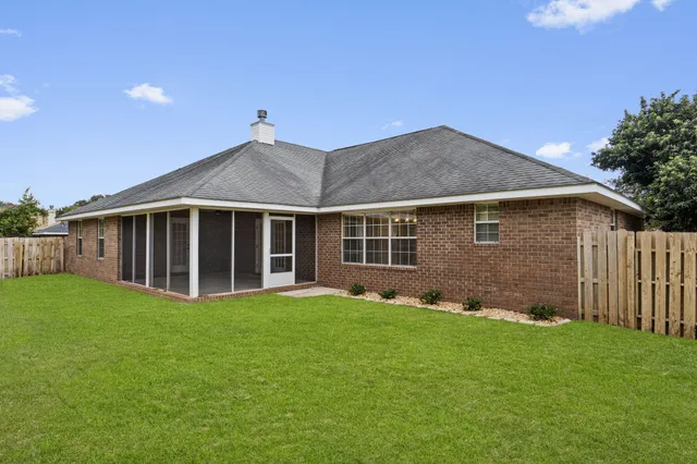 a view of a house with a yard and pathway