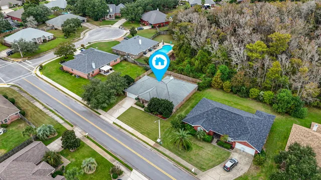 an aerial view of a house with a garden and swimming pool
