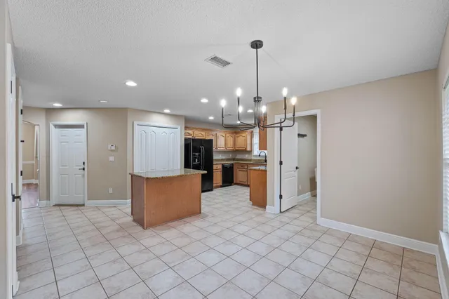 a view of a kitchen with refrigerator and microwave