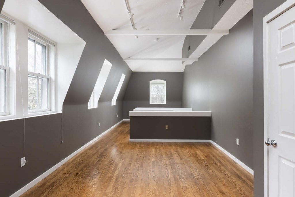 1175 Chestnut Street, Unit 2 Newton, MA 02464 - Photo 11 of 13 a view of a hallway with wooden floor and staircase