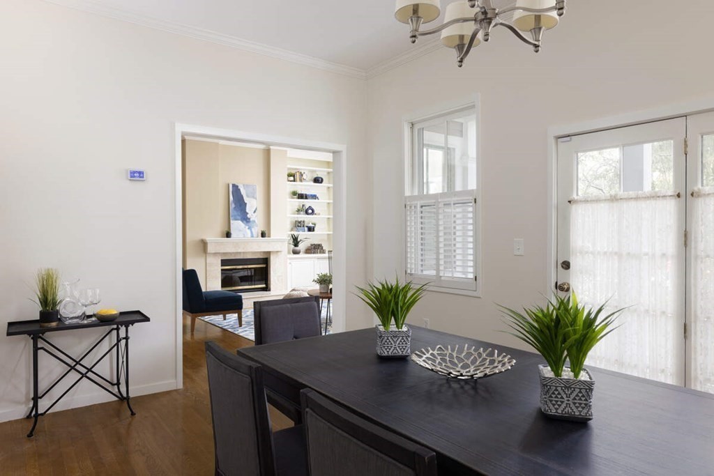 1175 Chestnut Street, Unit 2 Newton, MA 02464 - Photo 4 of 13 a dining room with furniture a potted plant and a window
