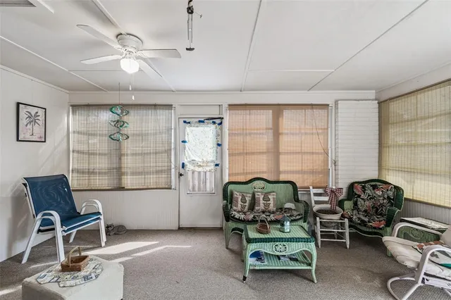 a view of a hallway view with wooden floor and living room