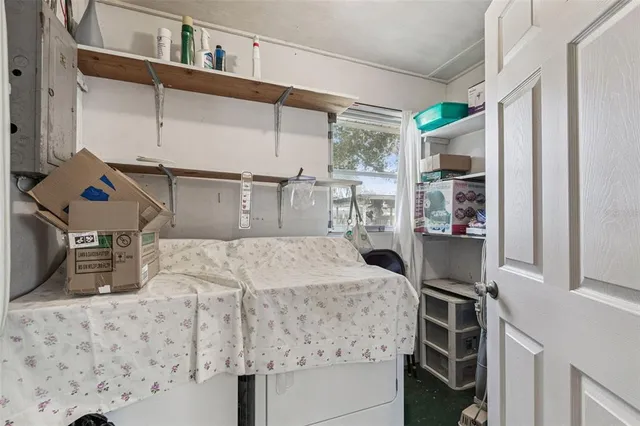 a bedroom with a large bed and a mirror