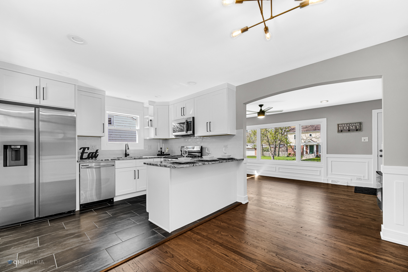 2141 Downey Road Homewood, IL 60430 - Photo 11 of 31 a kitchen with stainless steel appliances a stove a sink dishwasher a refrigerator and white cabinets with wooden floor