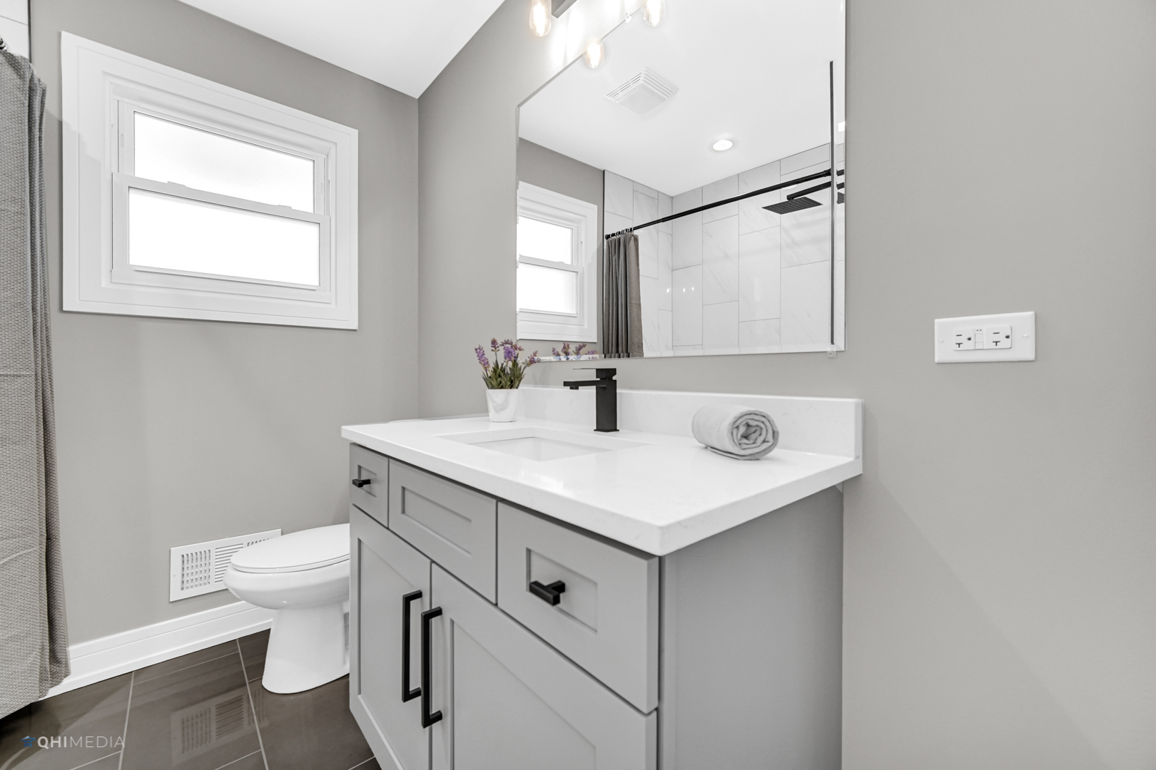 2141 Downey Road Homewood, IL 60430 - Photo 14 of 31 a bathroom with a sink a toilet a mirror and a window