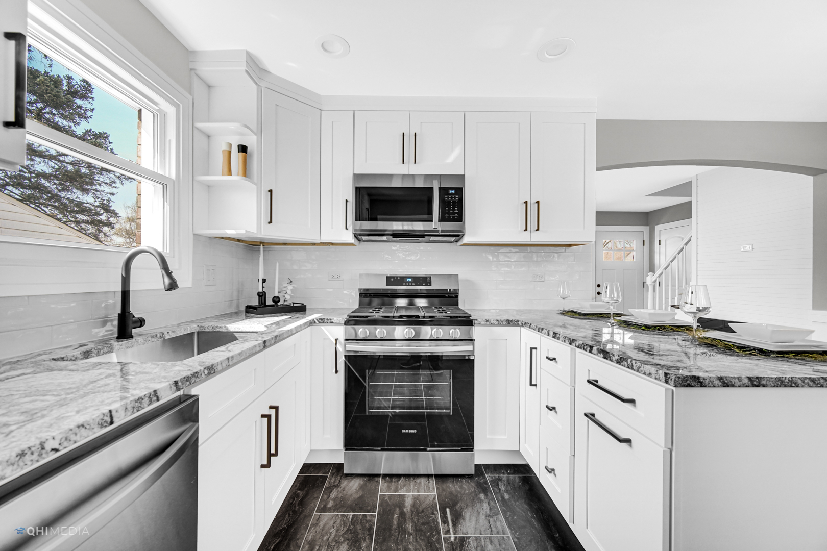 2141 Downey Road Homewood, IL 60430 - Photo 8 of 31 a kitchen with granite countertop a sink stainless steel appliances and white cabinets