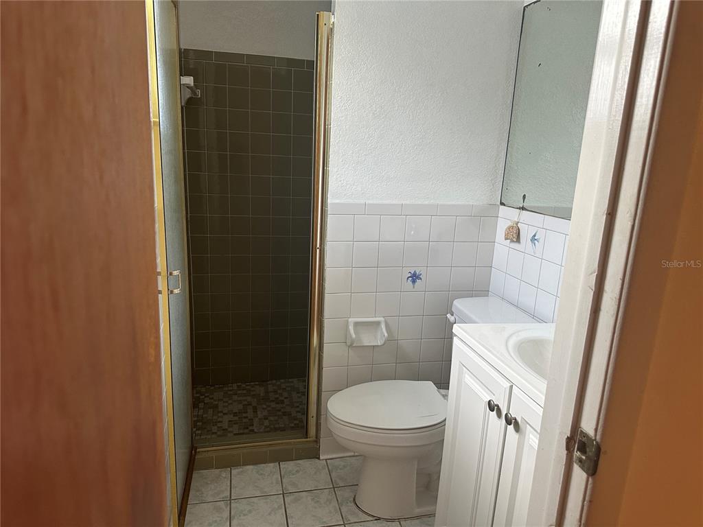 9741 Scenic Drive Port Richey, FL 34668 - Photo 12 of 17 a white toilet sitting next to a bathroom sink