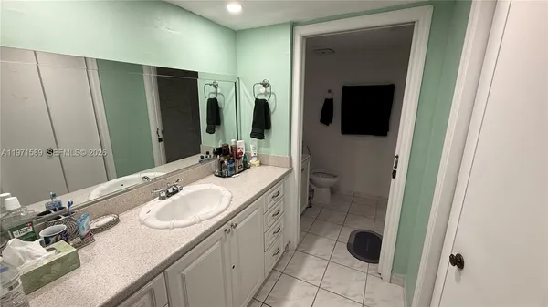 a bathroom with a double vanity sink and mirror