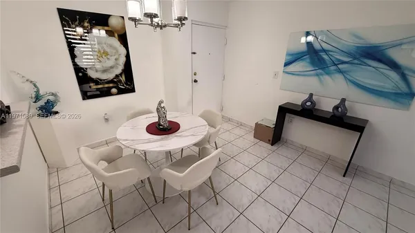 a table with white walls and a dining table with chairs