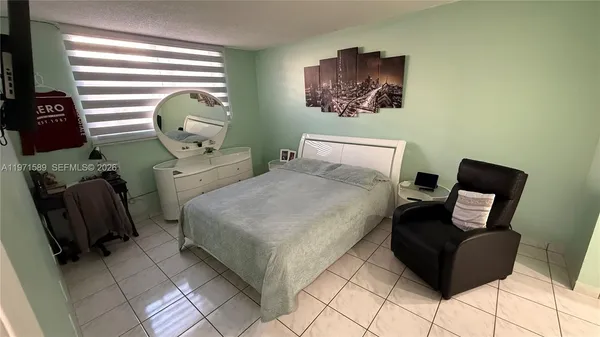 a bed room with a bed and chair
