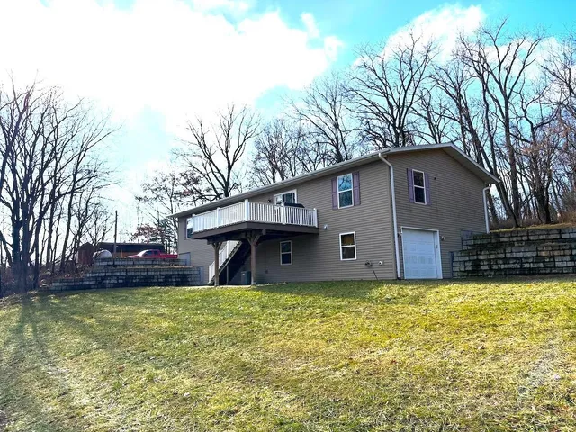 a front view of house with yard and trees