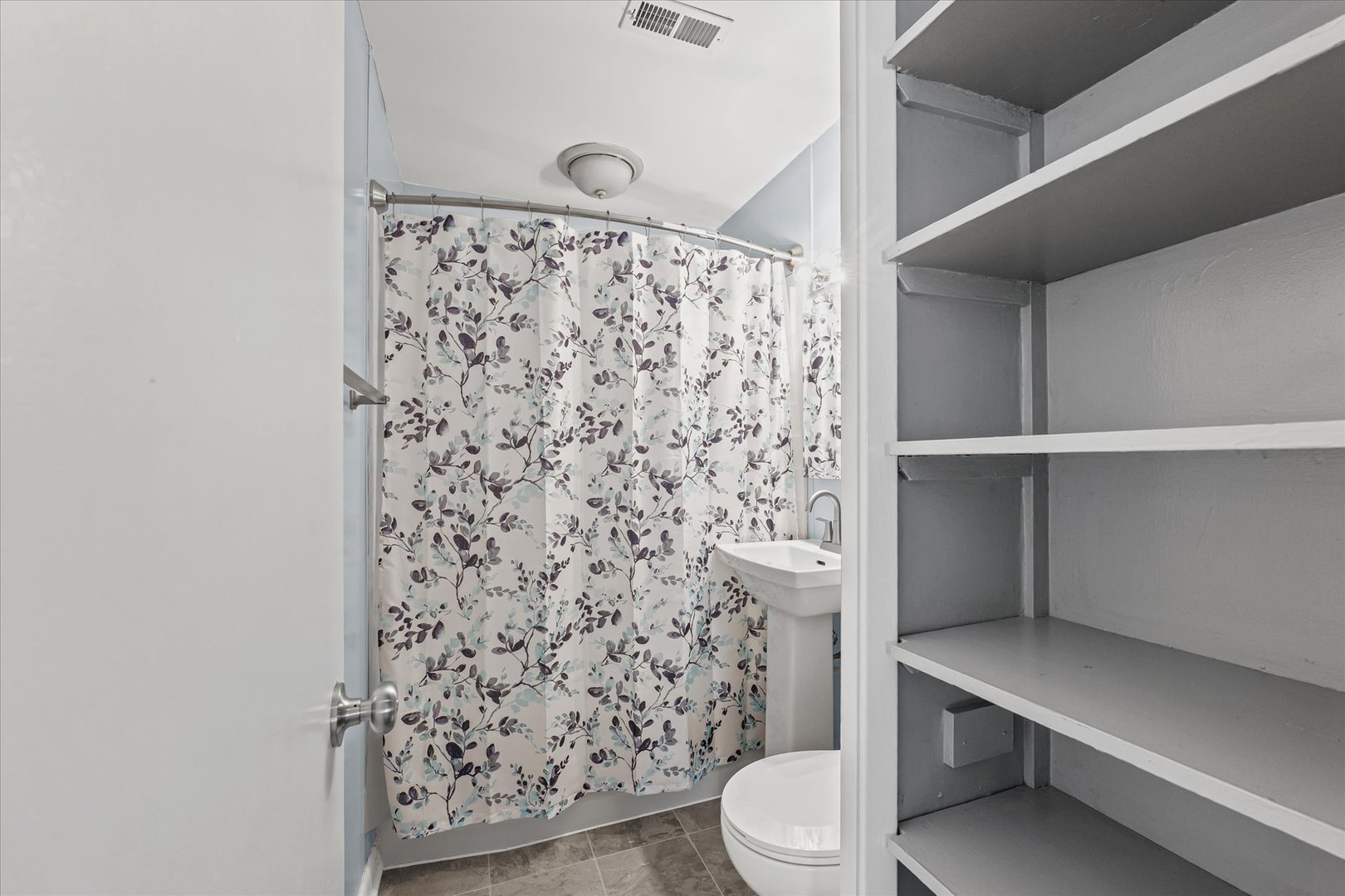 1116 Bel Aire Drive Rantoul, IL 61866 - Photo 16 of 27 a bathroom with a toilet and a shower curtain