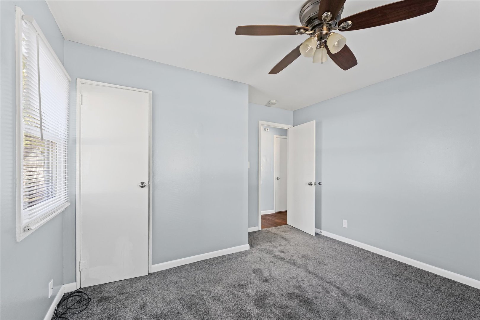 1116 Bel Aire Drive Rantoul, IL 61866 - Photo 20 of 27 a view of a room with a ceiling fan and a window