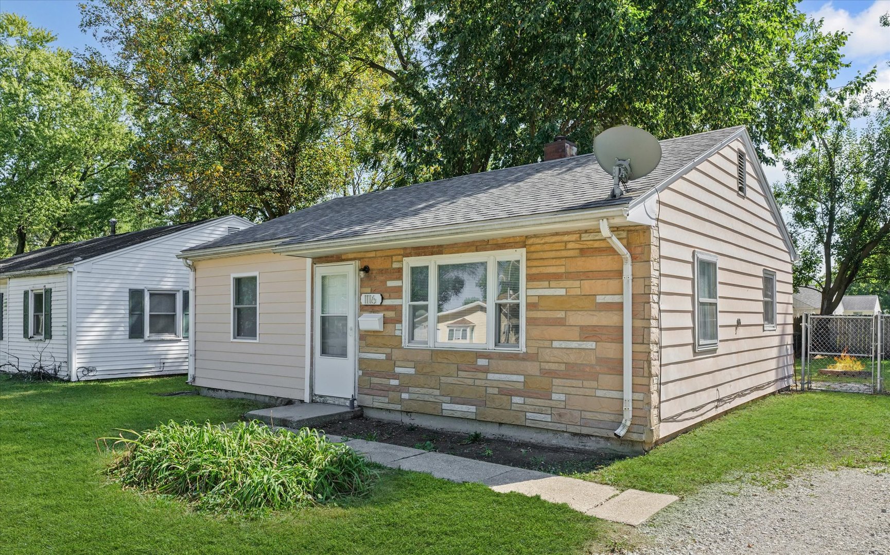 1116 Bel Aire Drive Rantoul, IL 61866 - Photo 2 of 27 a front view of a house with a garden