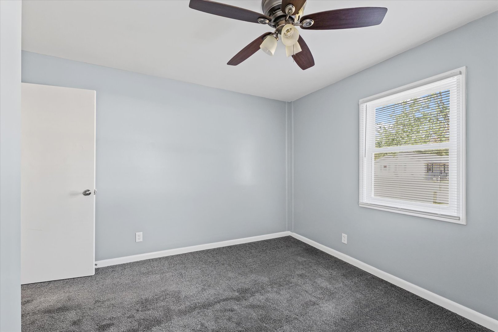 1116 Bel Aire Drive Rantoul, IL 61866 - Photo 21 of 27 an empty room with a window and a fan