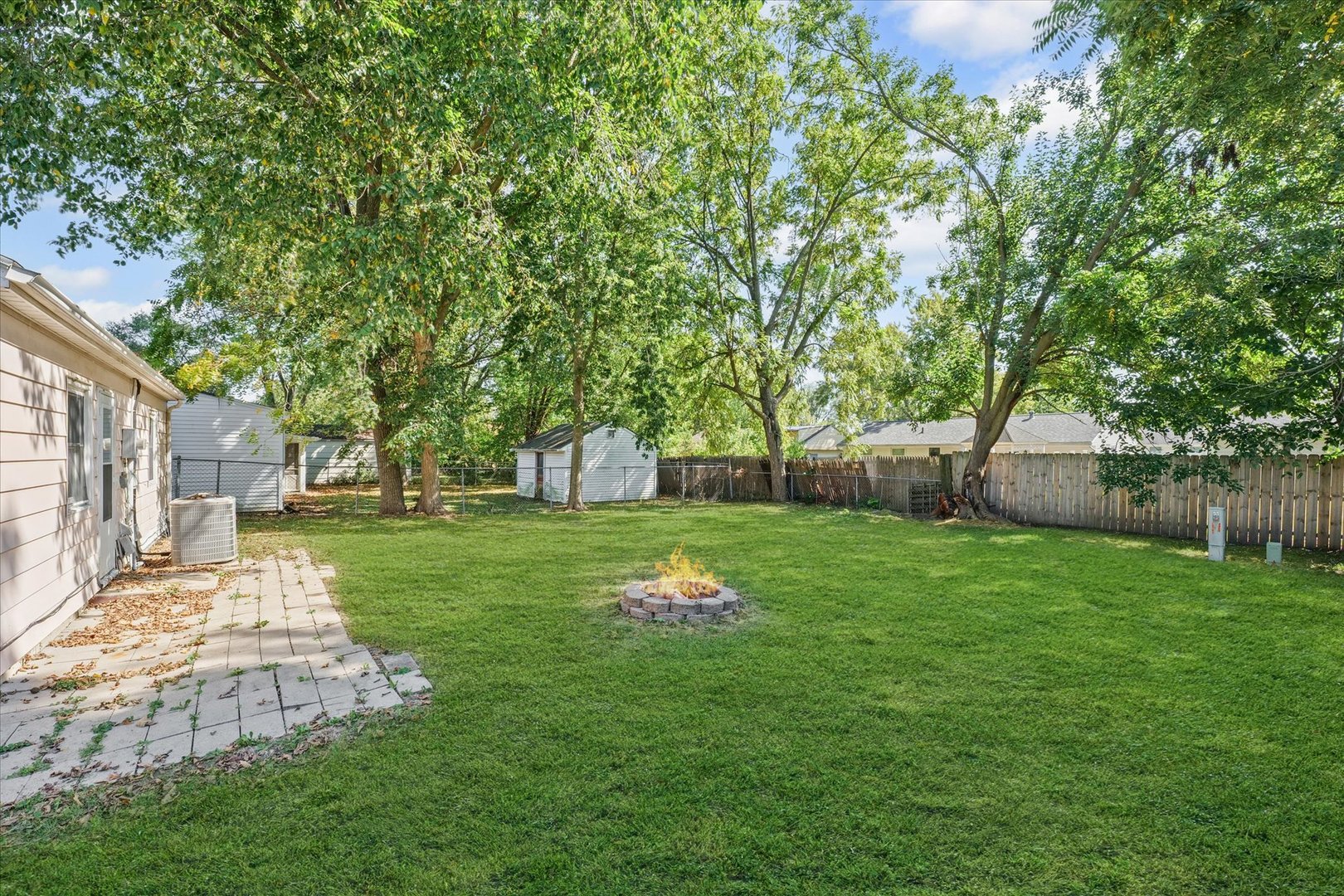 1116 Bel Aire Drive Rantoul, IL 61866 - Photo 23 of 27 a backyard of a house with table and chairs