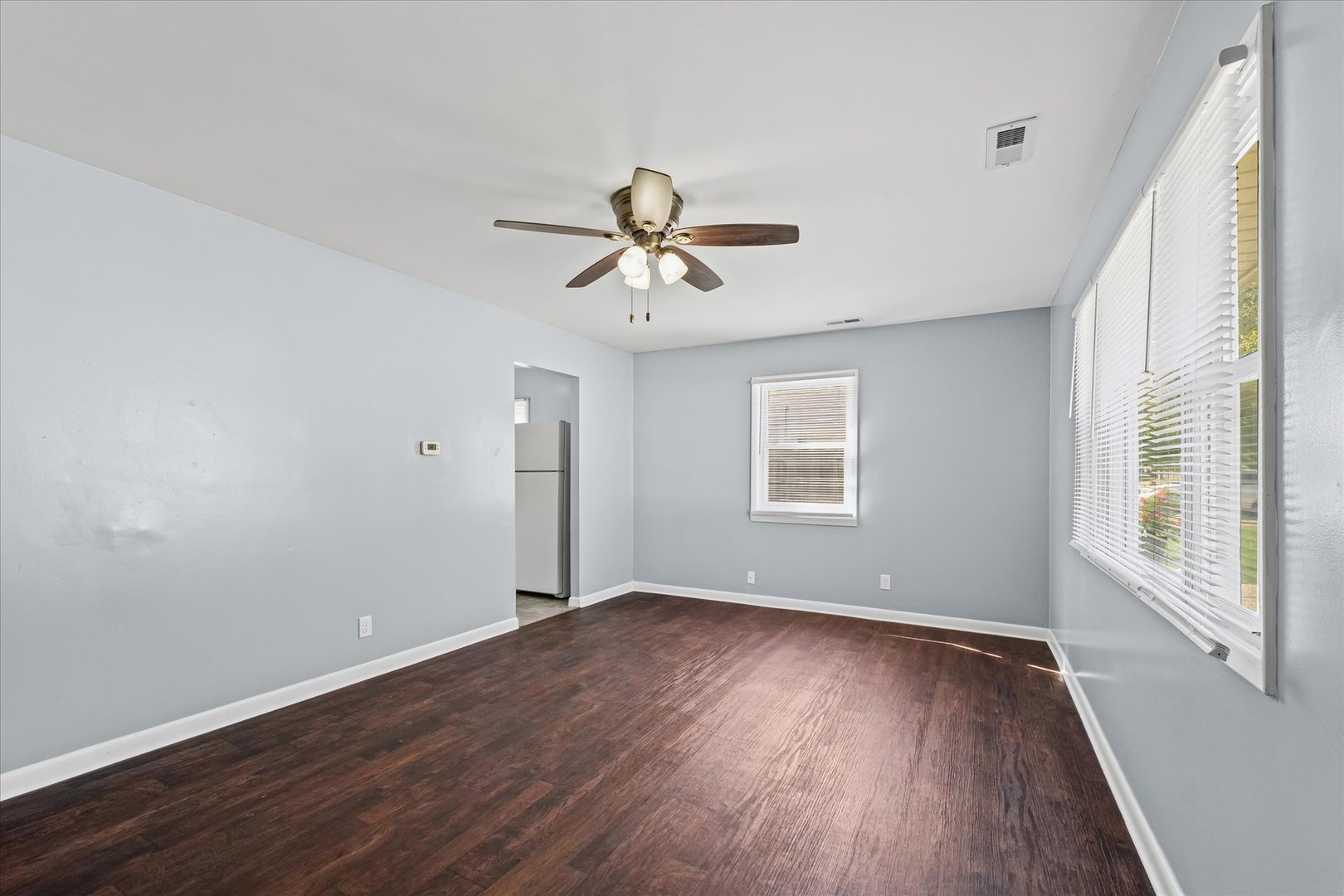 1116 Bel Aire Drive Rantoul, IL 61866 - Photo 5 of 27 an empty room with wooden floor and windows