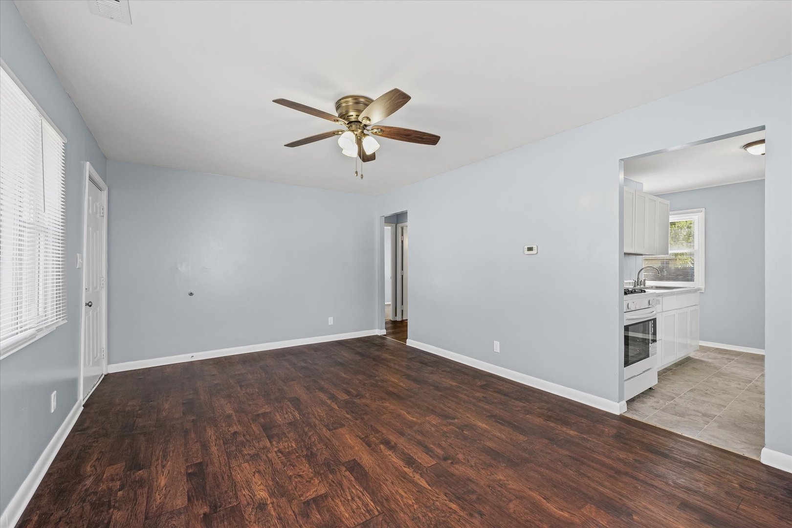 1116 Bel Aire Drive Rantoul, IL 61866 - Photo 7 of 27 wooden floor in an empty room with a window