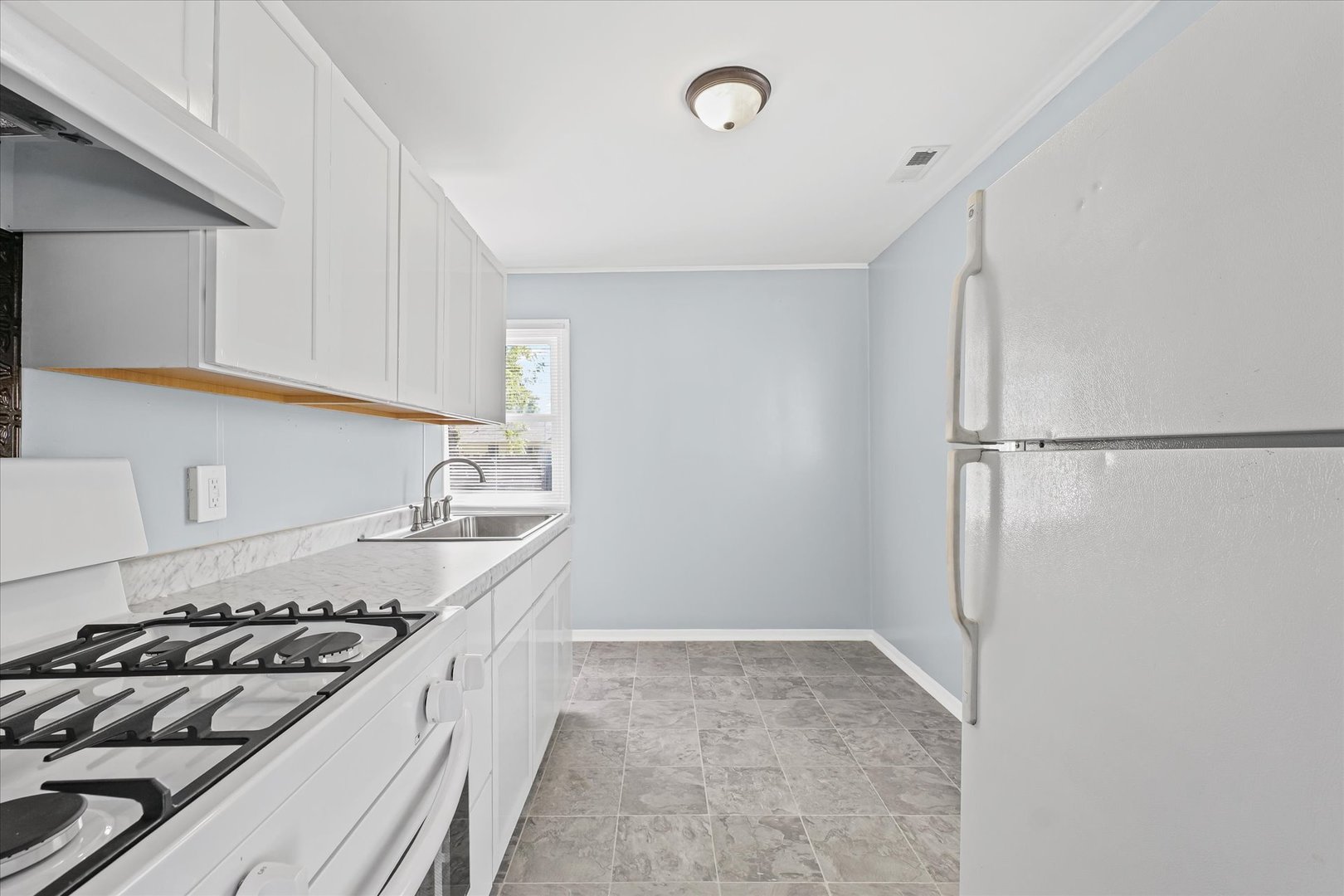 1116 Bel Aire Drive Rantoul, IL 61866 - Photo 9 of 27 a kitchen that has a sink and a stove