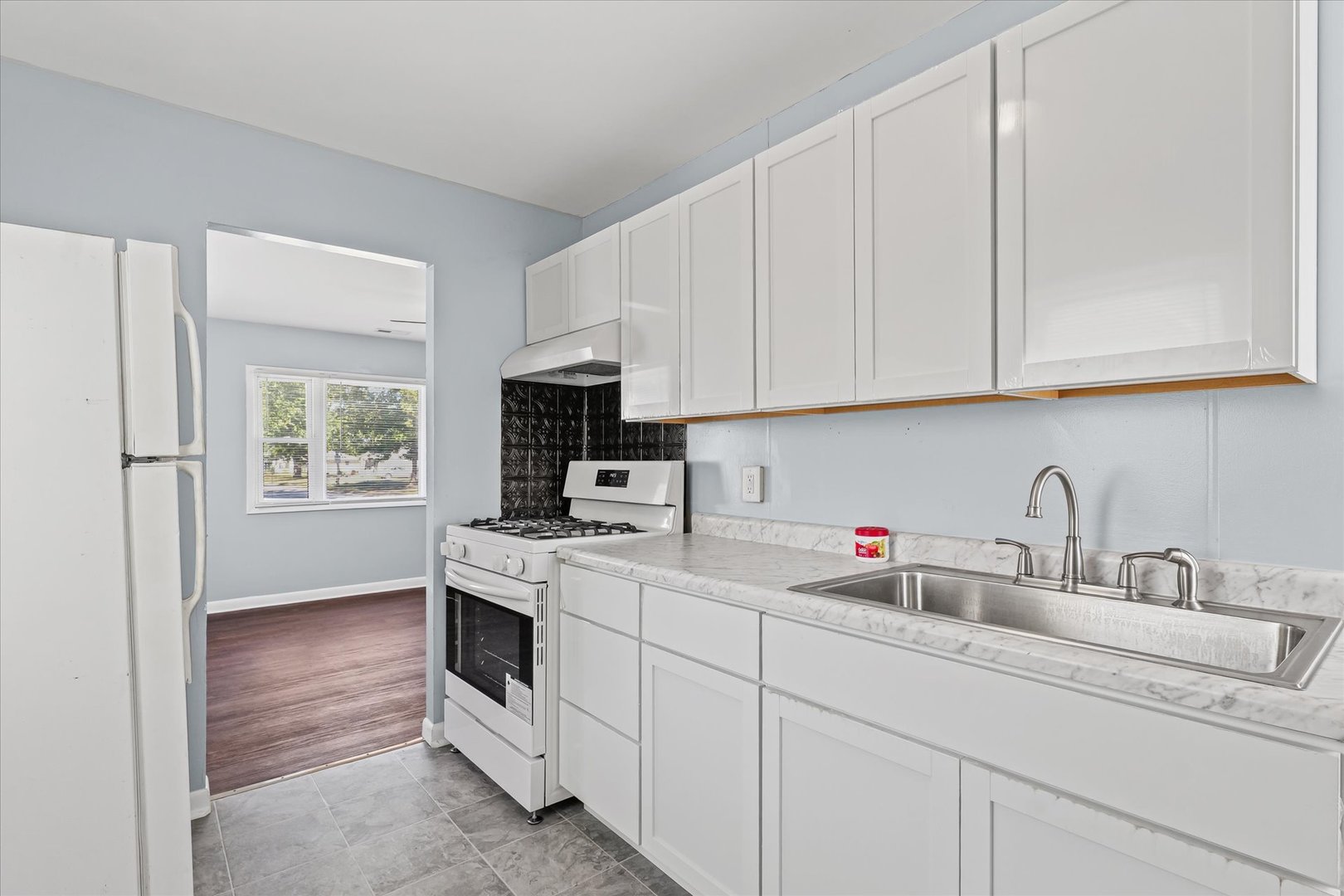 1116 Bel Aire Drive Rantoul, IL 61866 - Photo 10 of 27 a kitchen with white cabinets and sink