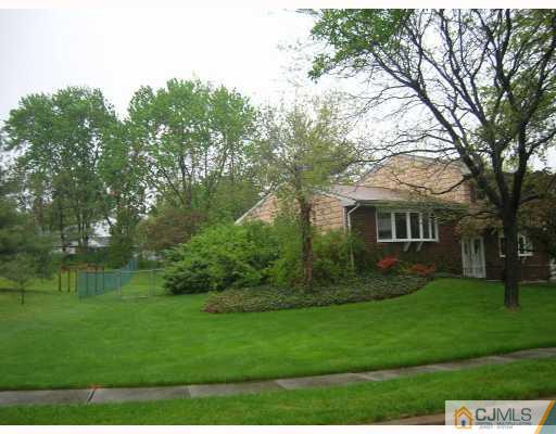 11 Perry Road East Brunswick, NJ 08816 - Photo 4 of 6 a view of a yard with plants and large trees