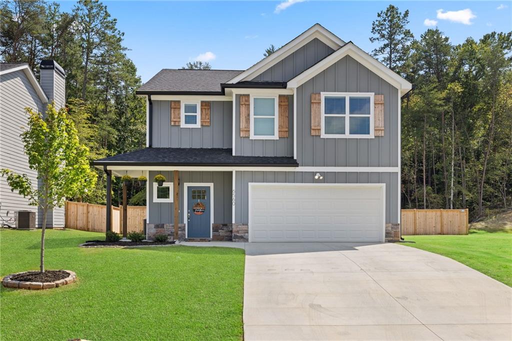 a front view of a house with a garden and plants