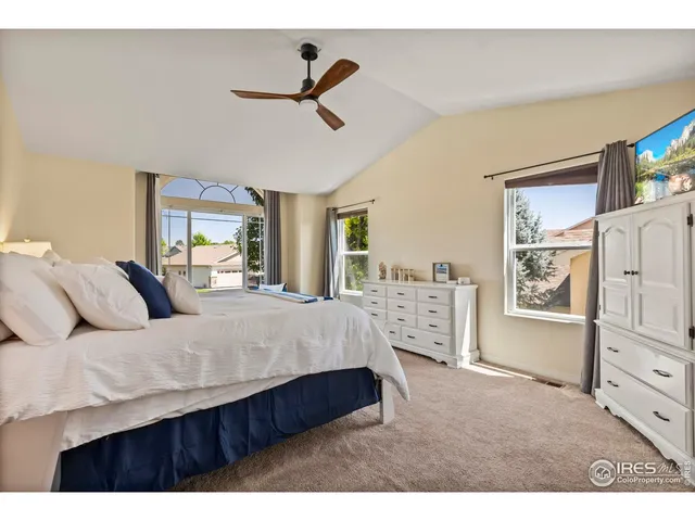 a living room with a bed furniture and a flat tv screen