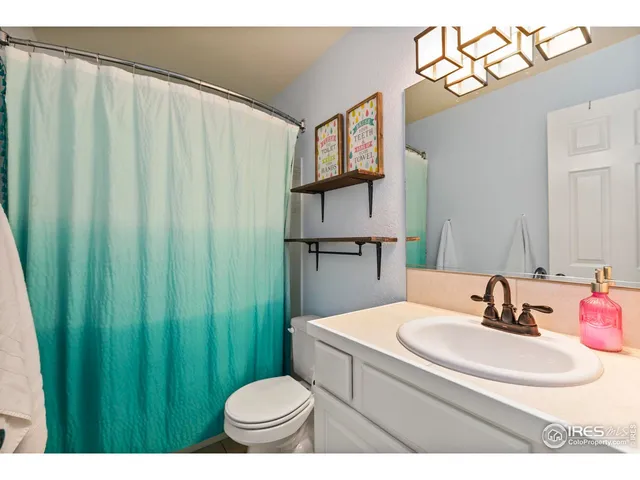 a bathroom with a sink toilet and a mirror