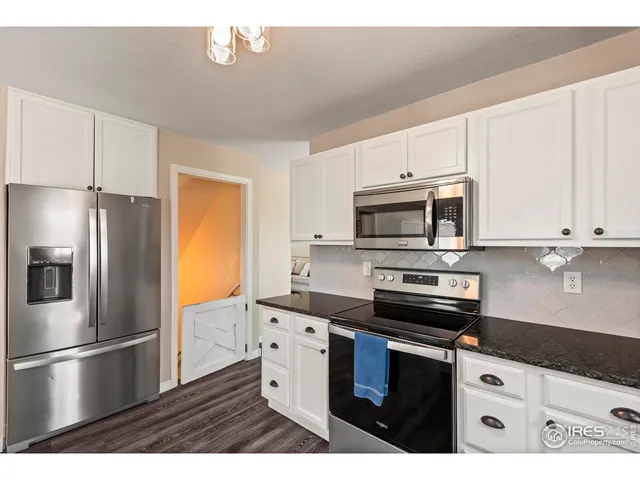 a kitchen with stainless steel appliances a refrigerator stove and microwave