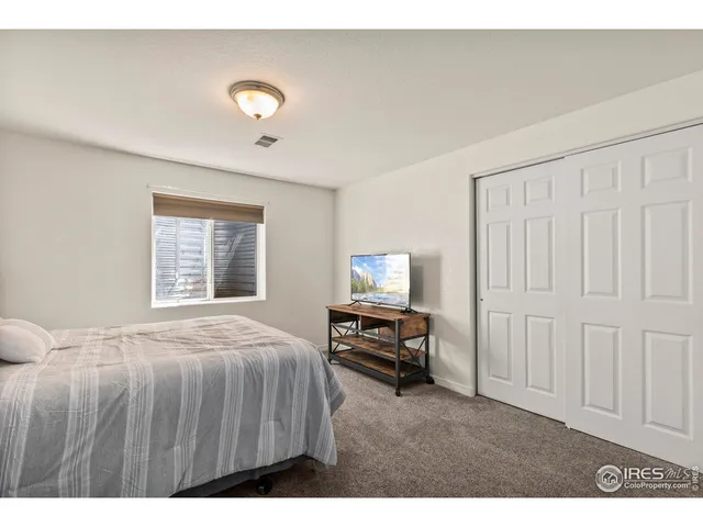 a bedroom with a bed and a tv