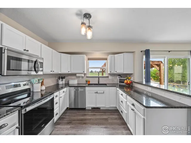 a kitchen with stainless steel appliances a sink stove and cabinets