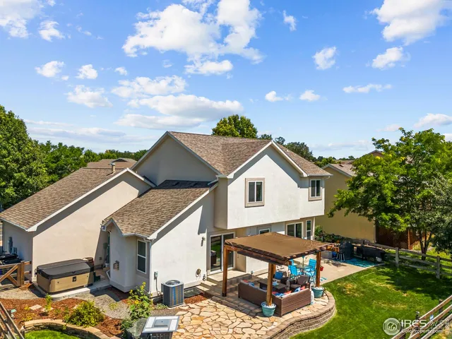 a view of a white house with a big yard and a large tree