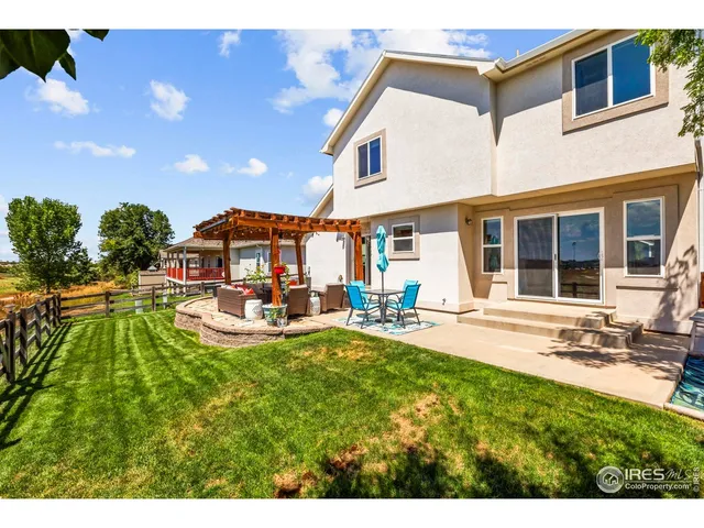 a view of a house with swimming pool and sitting area