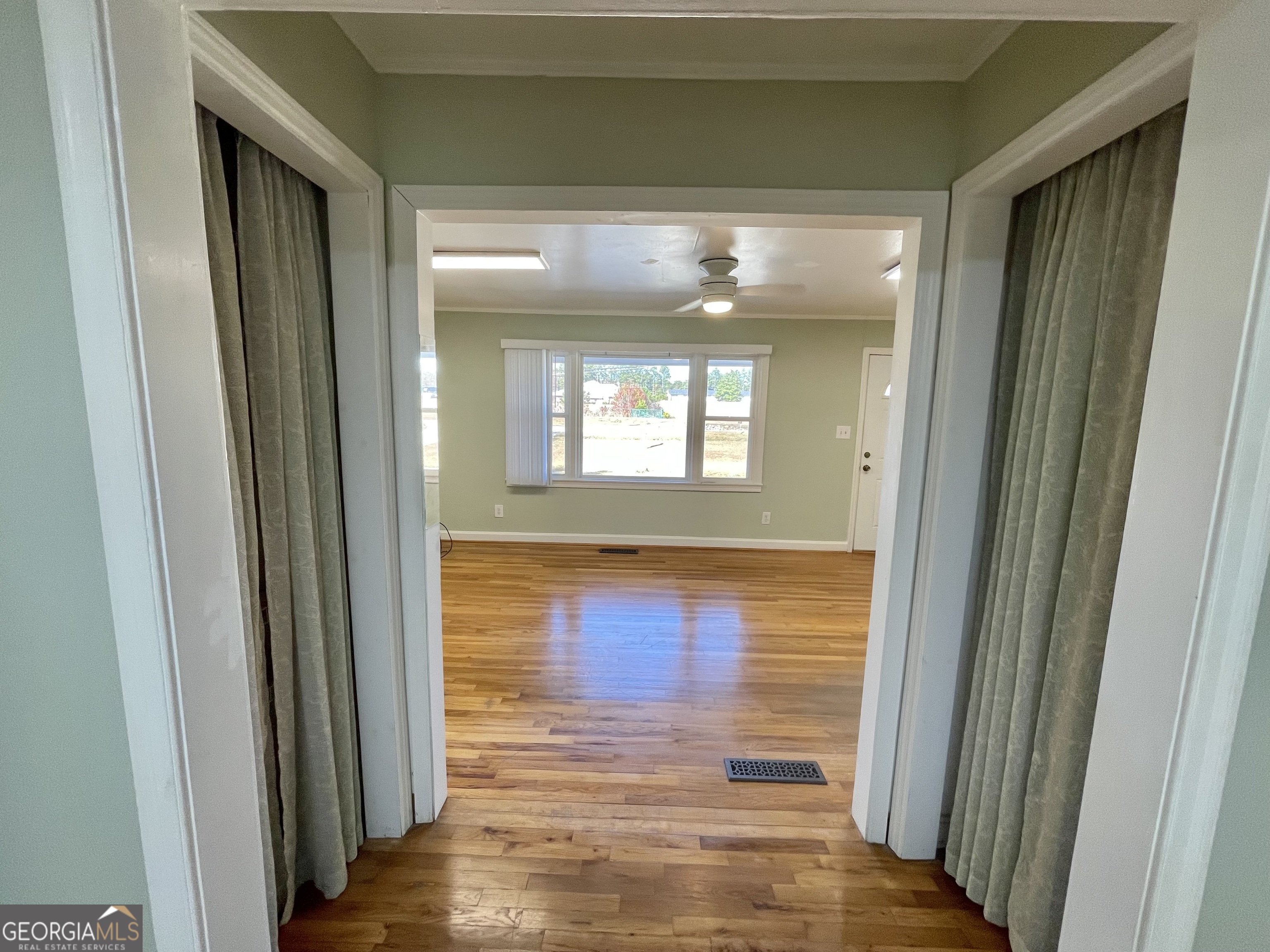 220 Airport Road Griffin, GA 30223 - Photo 11 of 23 a view of a hallway with wooden floor and a bathroom