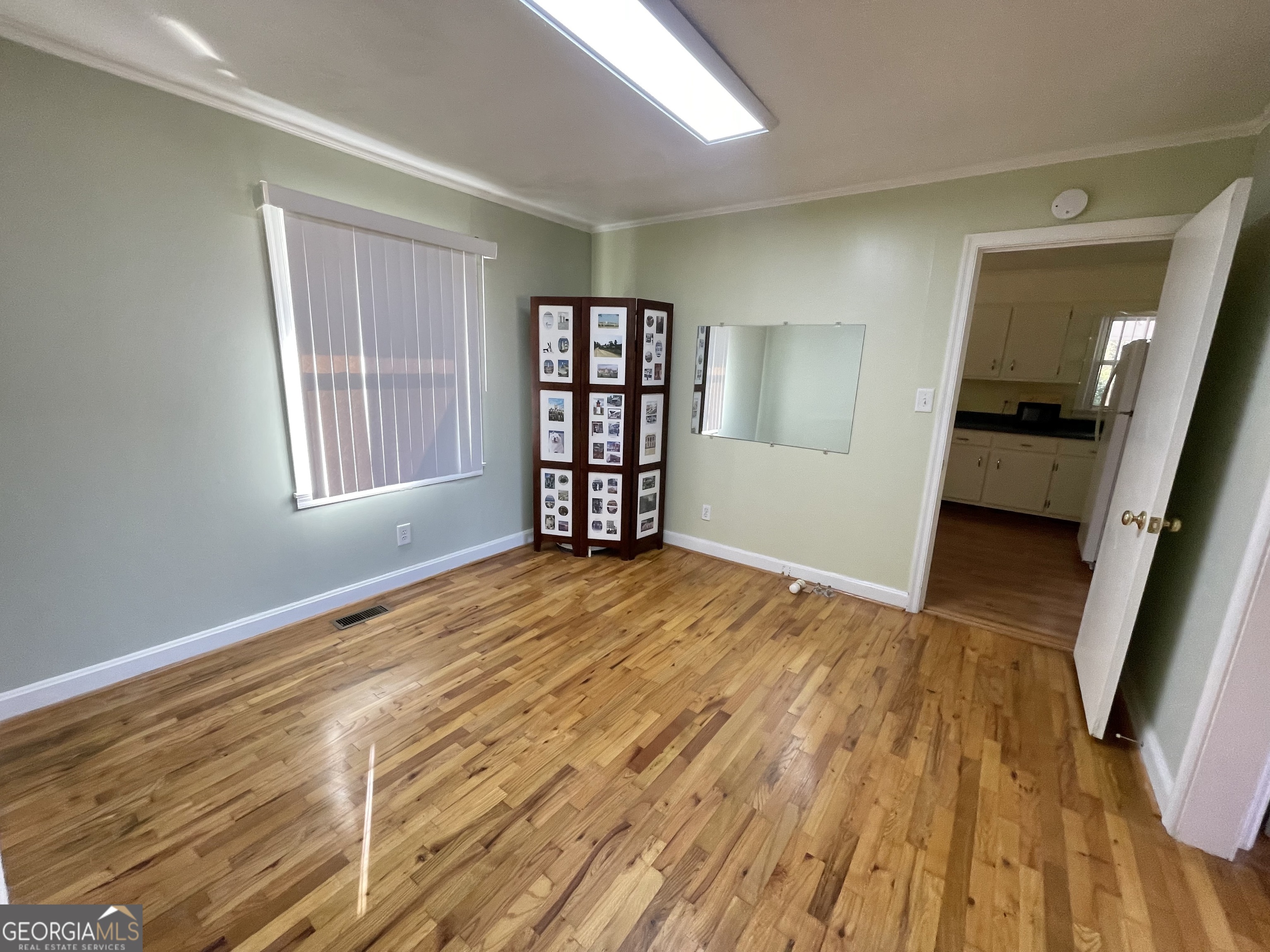 220 Airport Road Griffin, GA 30223 - Photo 12 of 23 a view of empty room with wooden floor and fan