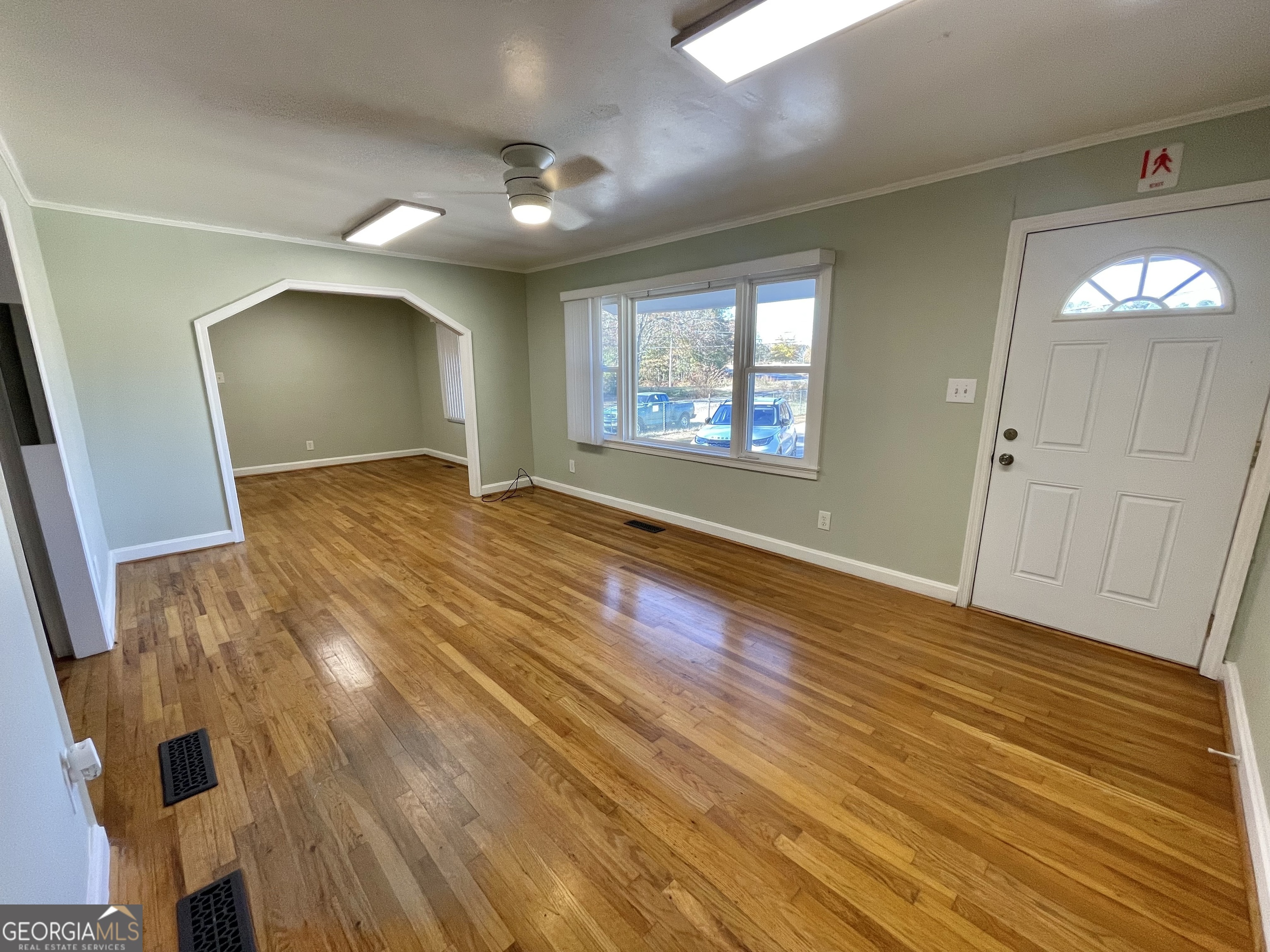 220 Airport Road Griffin, GA 30223 - Photo 16 of 23 an empty room with wooden floor and windows