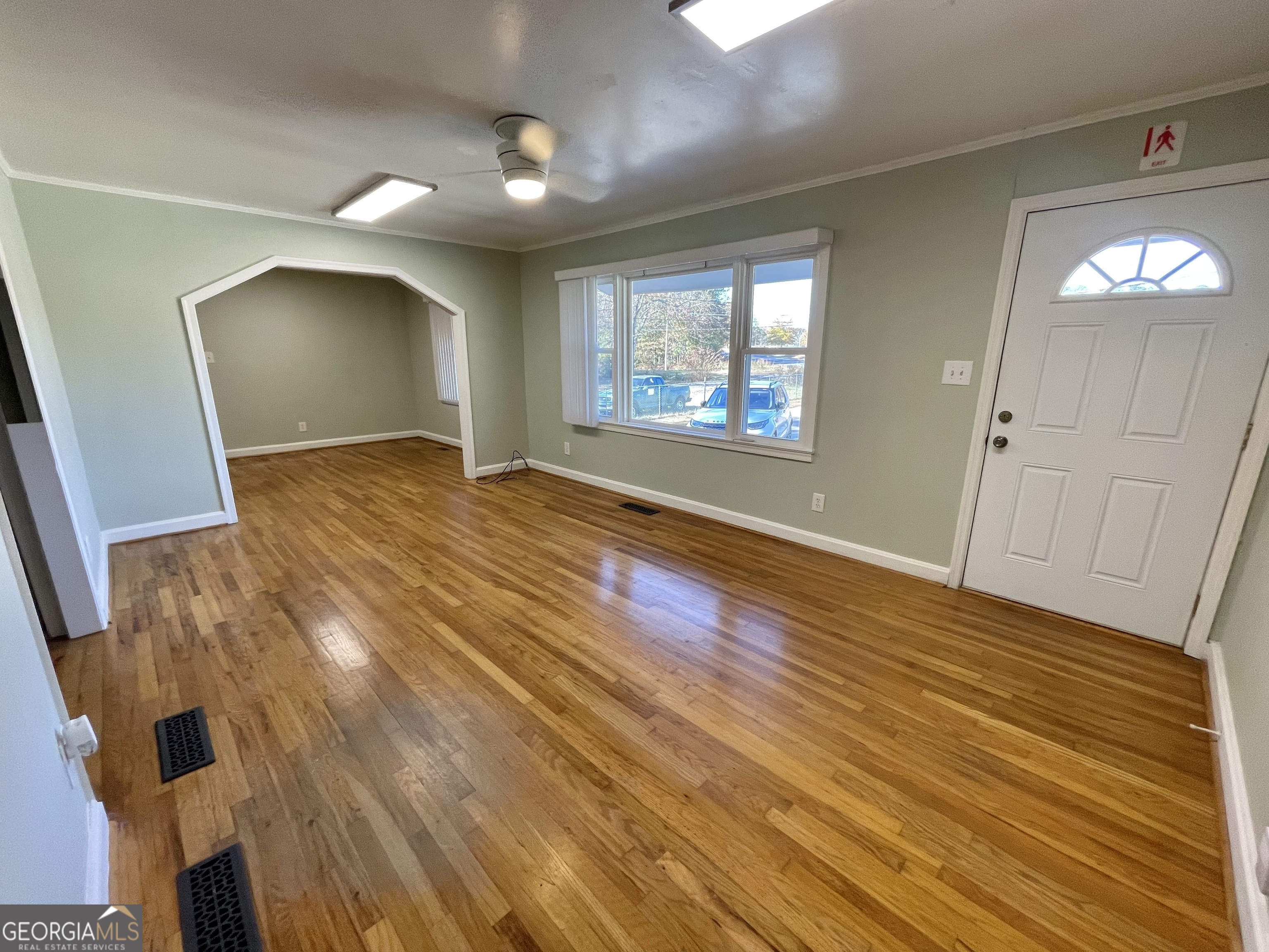 220 Airport Road Griffin, GA 30223 - Photo 17 of 23 an empty room with wooden floor and windows