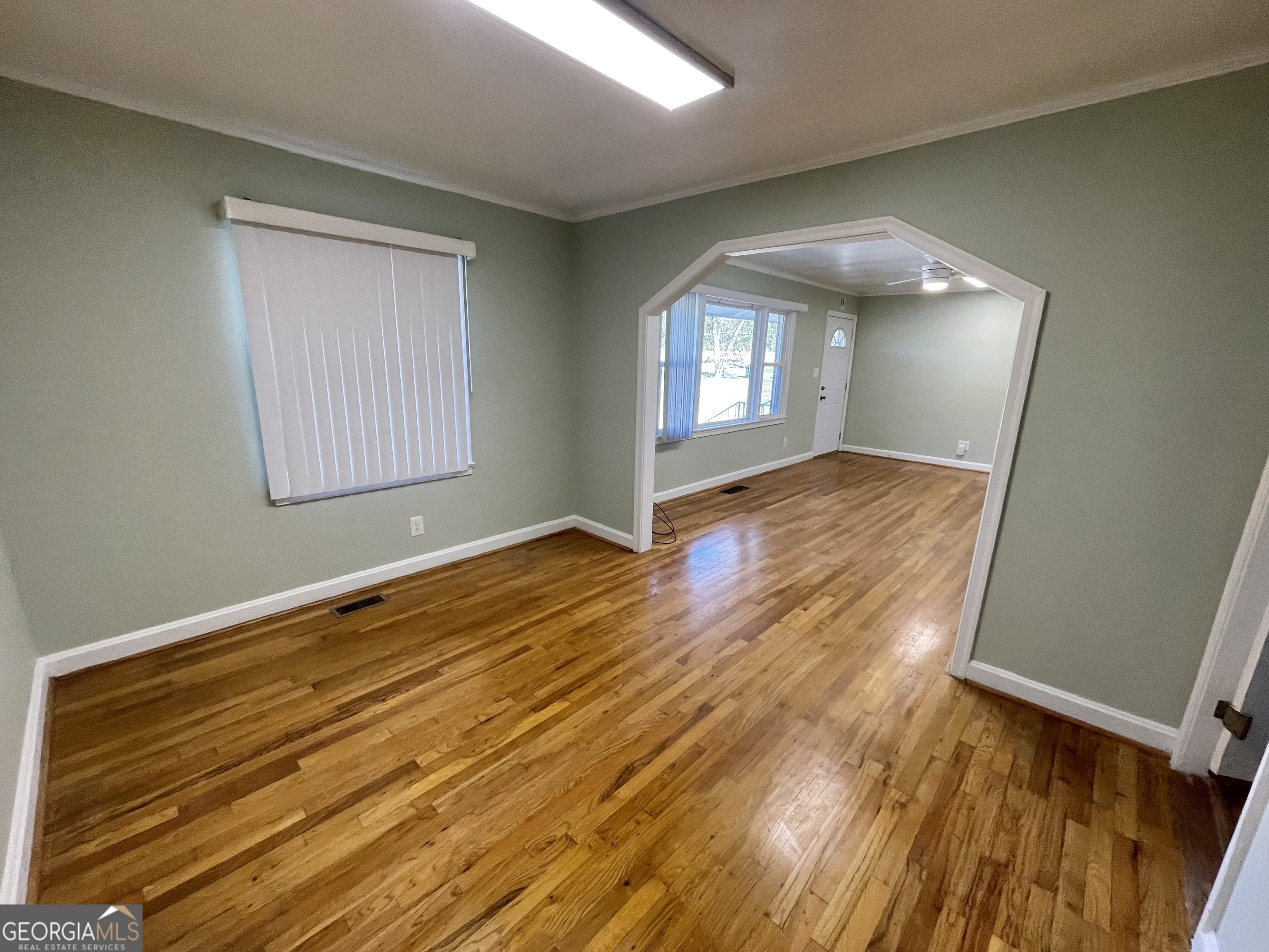 220 Airport Road Griffin, GA 30223 - Photo 3 of 23 an empty room with wooden floor and windows