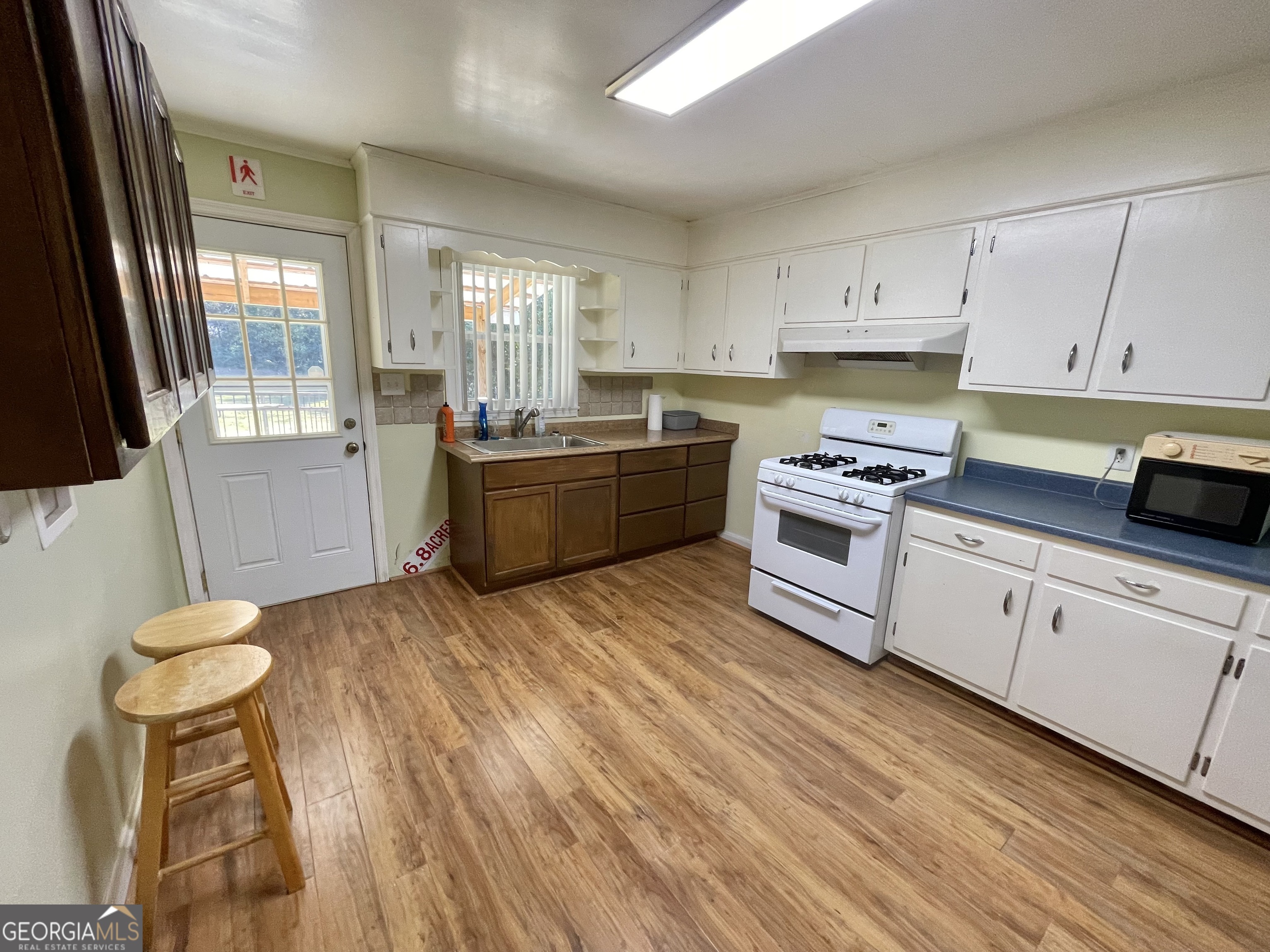 220 Airport Road Griffin, GA 30223 - Photo 7 of 23 a kitchen with a sink appliances and cabinets