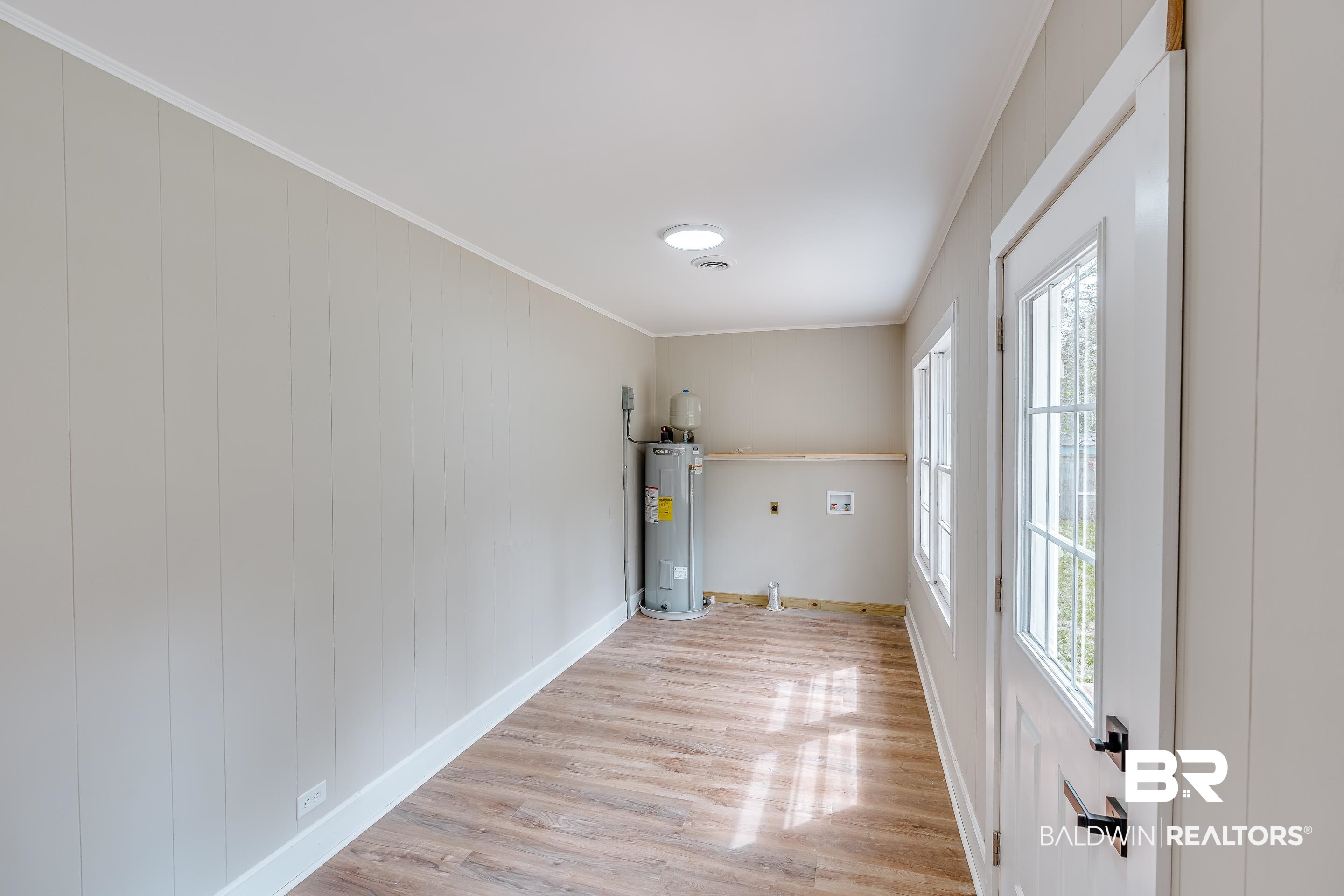 8001 16th Street Irvington, AL 36544 - Photo 17 of 35 Washroom featuring light wood finished floors, crown molding, hookup for an electric dryer, electric water heater, and hookup for a washing machine