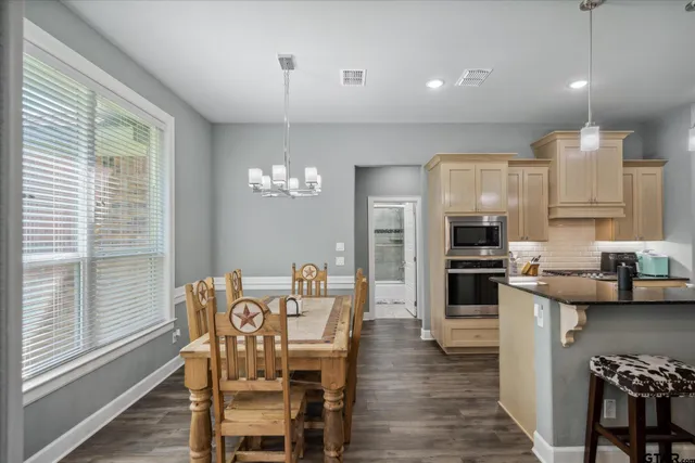 a view of a dining room with furniture and wooden floor