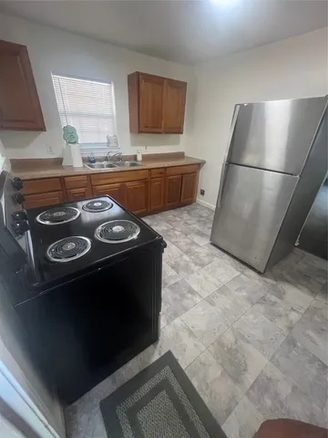 a kitchen with a stove and a refrigerator