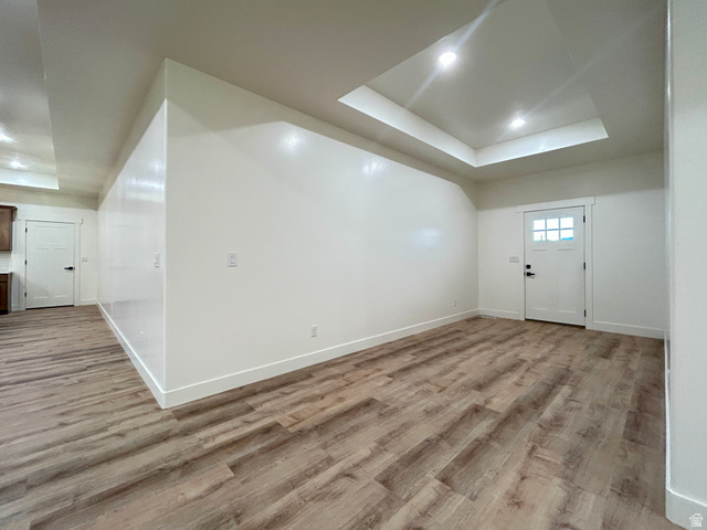 6 South 450th West Gunnison, UT 84634 - Photo 12 of 45 Spacious room featuring wood-finish flooring, white baseboards, and a tray ceiling with recessed lighting