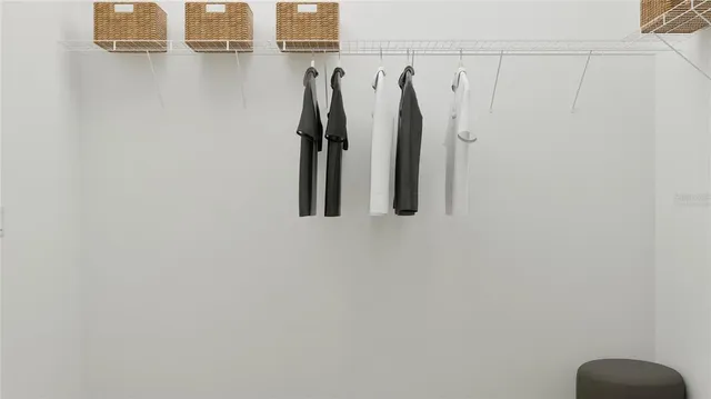 a view of walk in closet with clothes