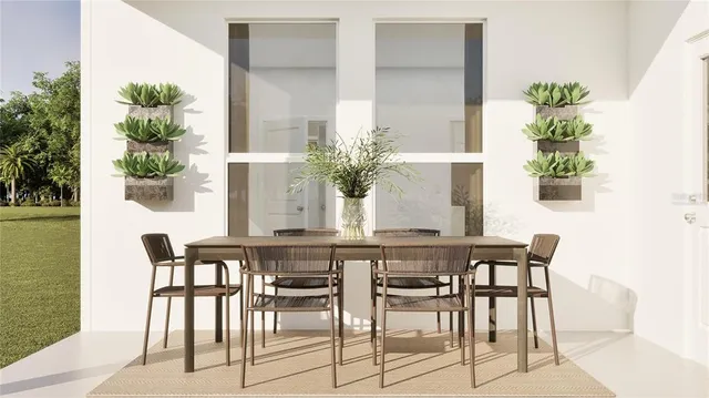 a dining room with furniture and potted plant