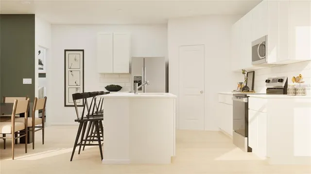 a view of kitchen with furniture and refrigerator