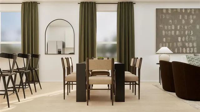 a view of a dining room with furniture and a window